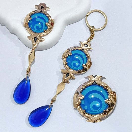 Genshin Impact Furina Vision Keychain: gold, blue stylized water swirl theme, fantasy cartoon style