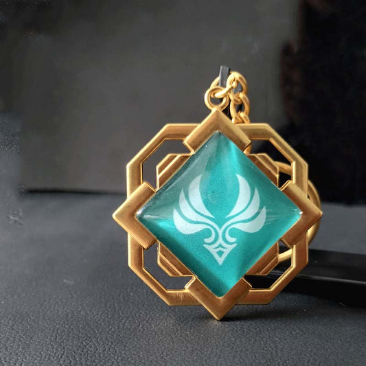 Liyue Vision Key Chain: Genshin Impact: gold, teal stylized white floral/crest emblem, fantasy-inspired geometric style
