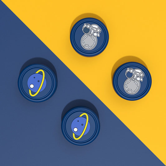 Switch OLED Thumb Grips with Designs: dark blue, yellow space theme (astronaut and ringed planet), cartoon style